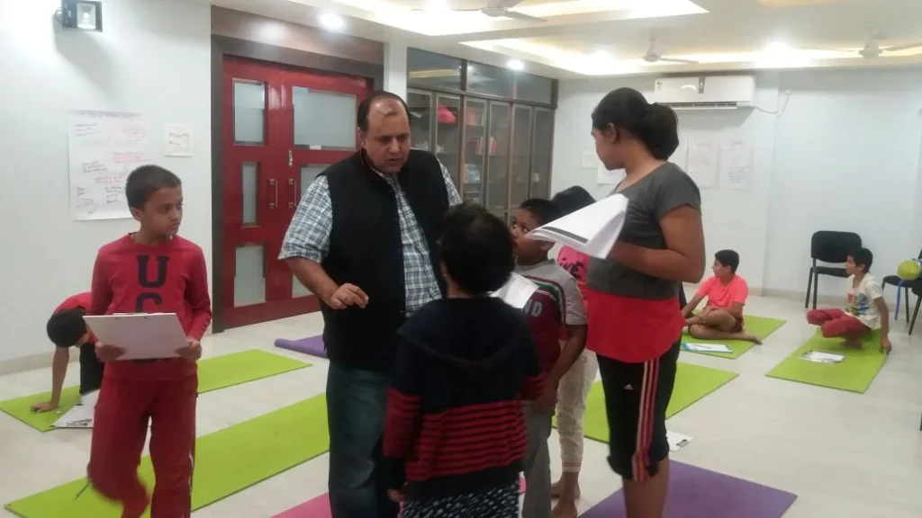 Dr. Naveen Raina, psychiatrist, life coach, and meditation practitioner, smiling in professional attire, representing holistic wellness, life coaching, and mental health guidance.